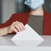 Ballot Box with Person Casting a Vote