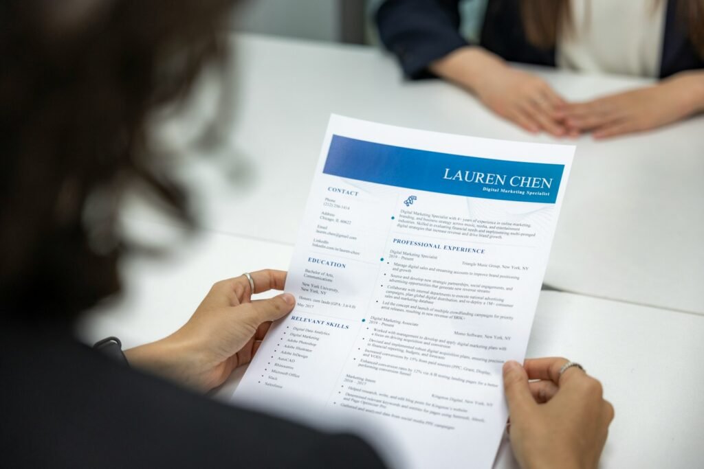 "100 Job Applications, One Interview" - What Challenges Does Youth Face in Employment? 3 a woman is reading a resume at a table